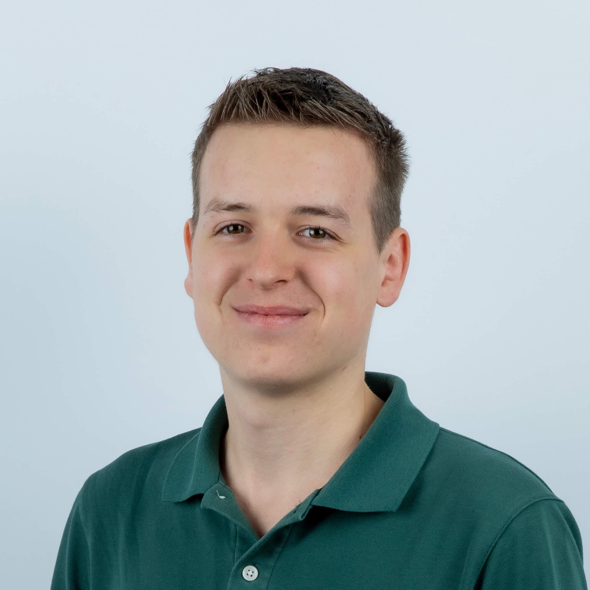 Person peeking from behind laptop